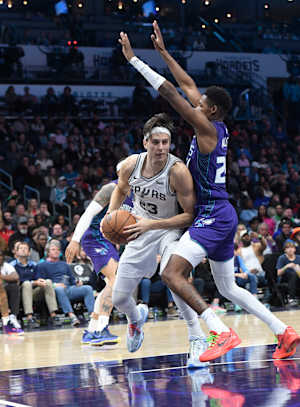 Jan 19, 2024; Charlotte, North Carolina, USA; San Antonio Spurs forward Zach Collins (23) moves past Charlotte Hornets guard forward Brandon Miller (24) during the second half at the Spectrum Center.